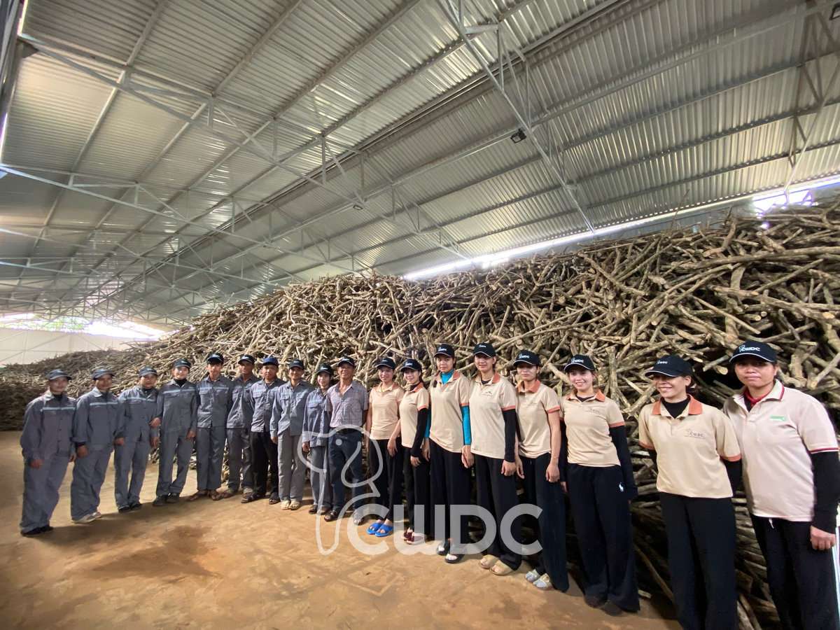 Two CWDC Vietnam production teams, raw material handling and quality staff, standing together in the warehouse